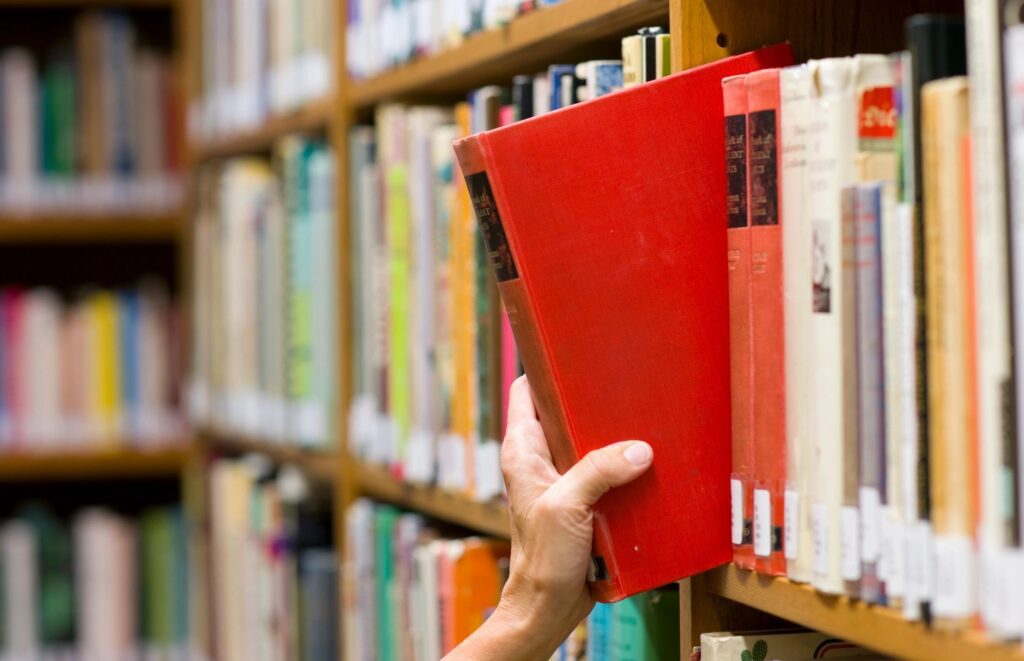 Hand reaching for library book